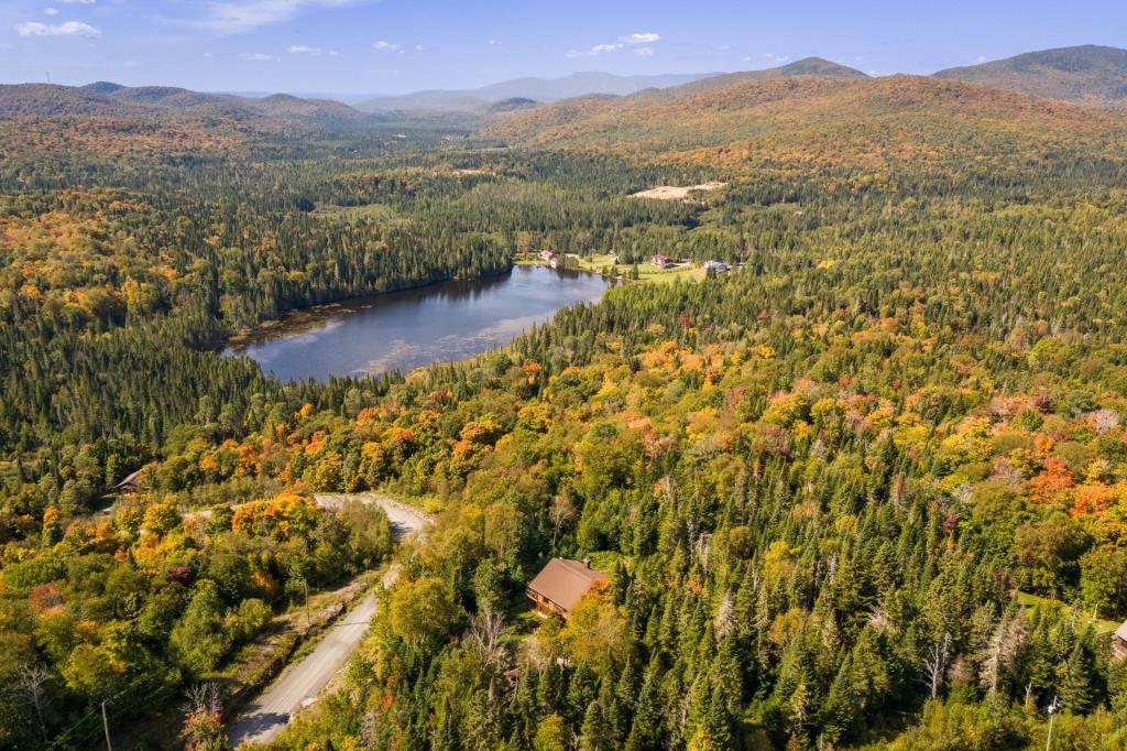 Vendu meublé! Superbe cottage en bois rond niché sur un site digne d'une carte postale