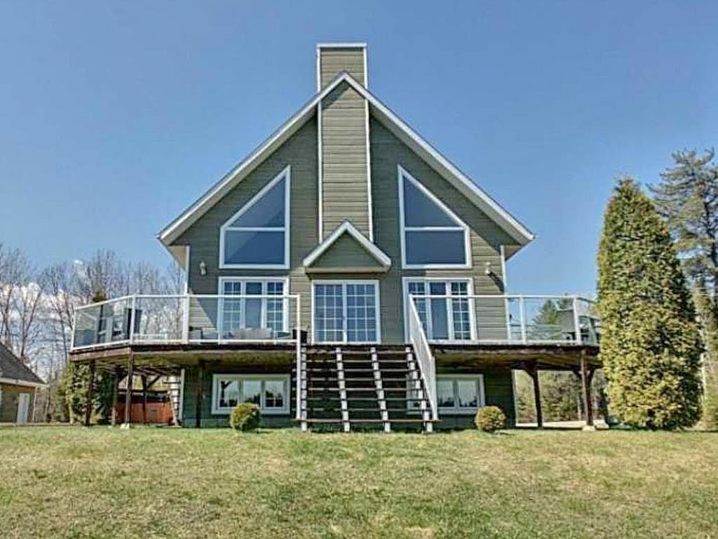 Élégant cottage sur la rive d'un lac bordé de nature généreuse