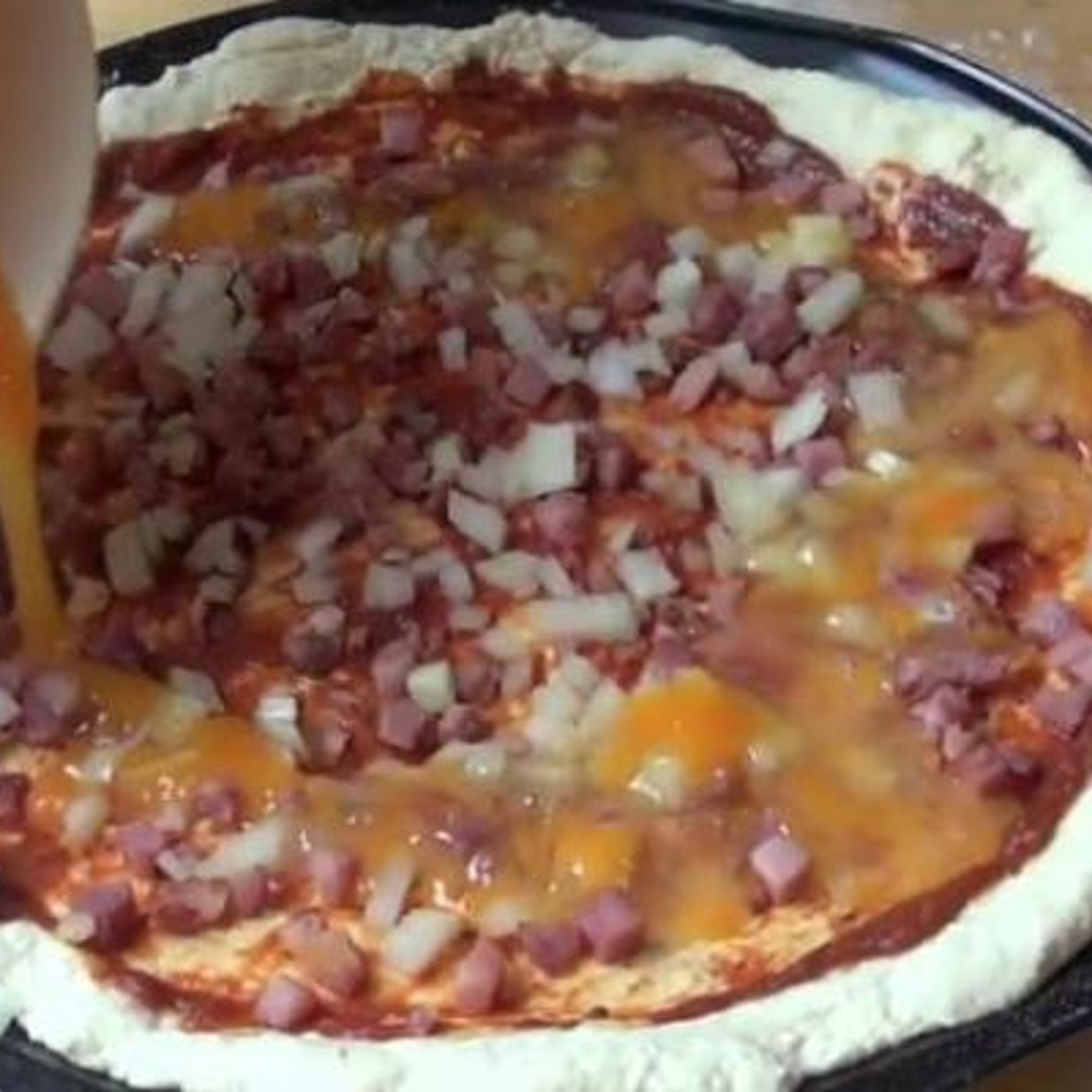 Il verse des oeufs sur sa Pizza avant de la cuire! Le résultat vous mettra l'eau à la bouche!