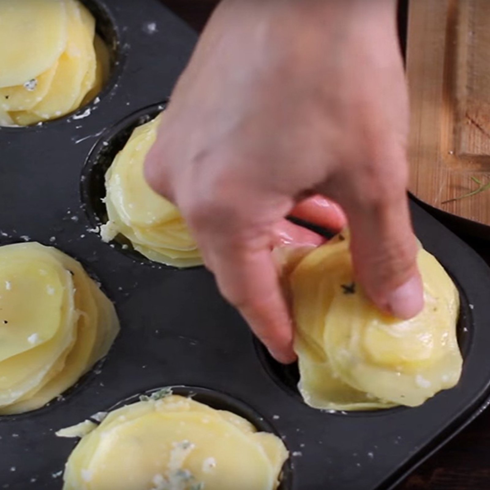 Elle dépose des tranches de pommes de terre dans son moule à muffins... Au final, le résultat est à couper le souffle!