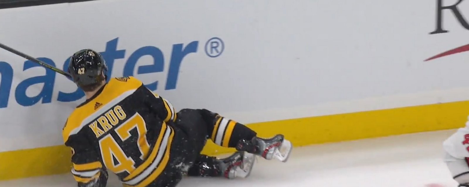 Torey Krug leaves the game after a big hit from Tom Wilson.