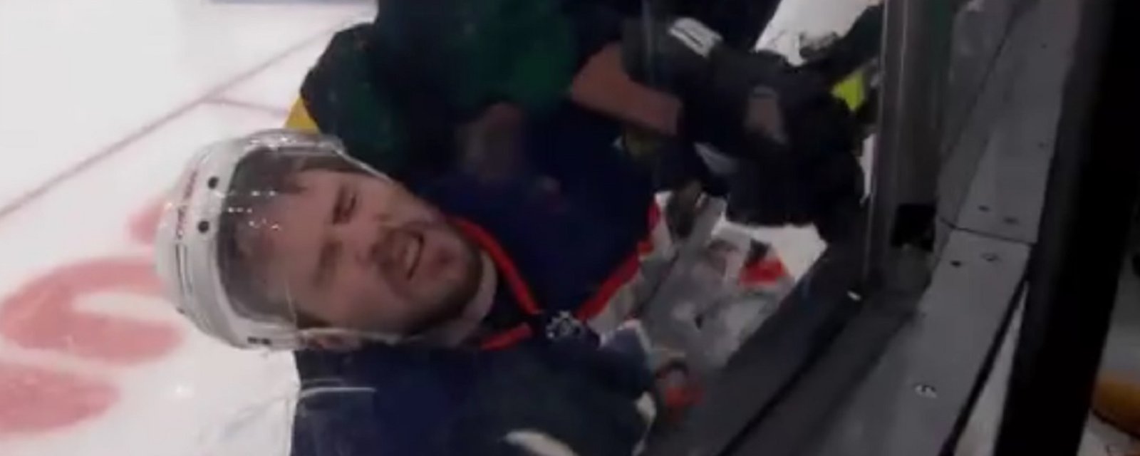Brad Marchand drives Kris Russell into the boards from behind. 