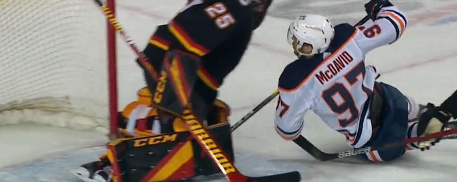 Connor McDavid slams into Jacob Markstrom.