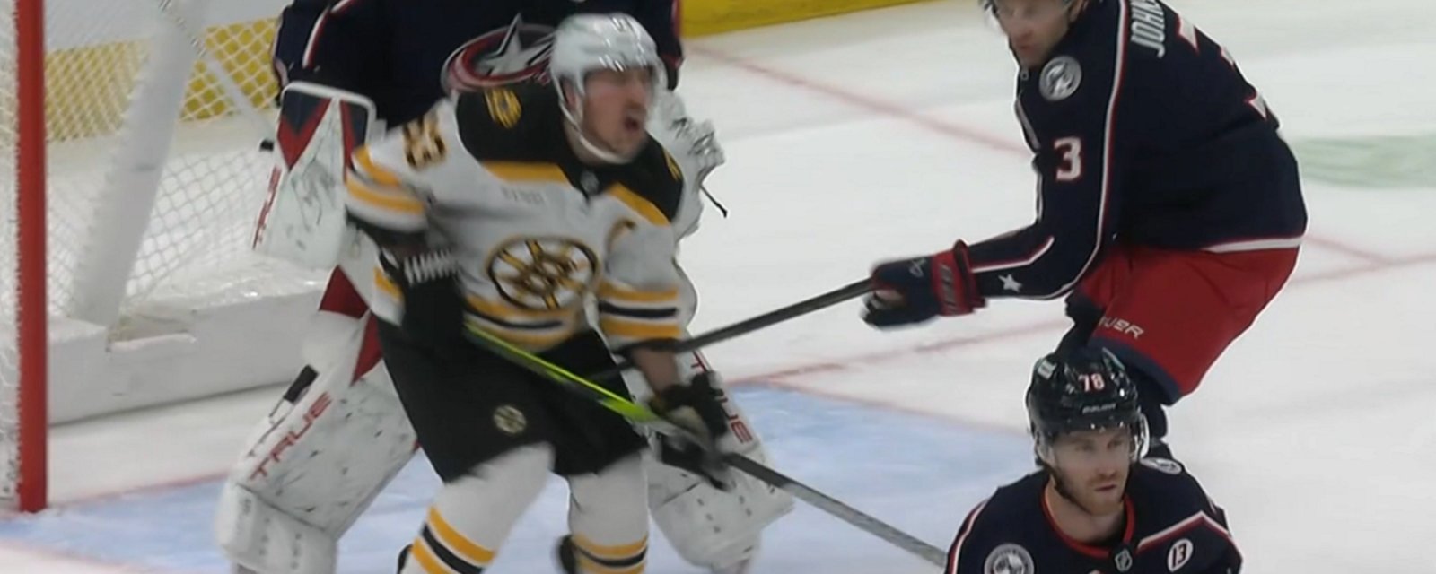 Brad Marchand goes down after blatant low blow.