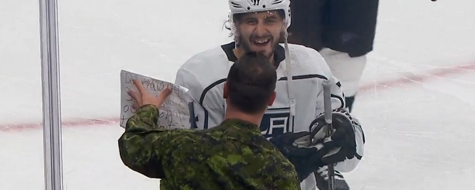 Phillip Danault works out a trade with Canadian Armed Forces member during warmups.