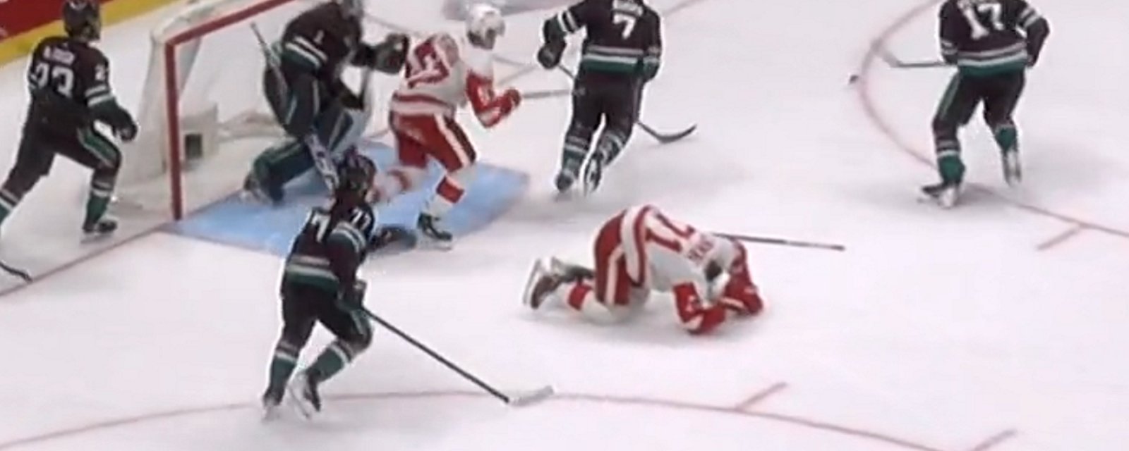Dylan Larkin injured after a cross check to the back.