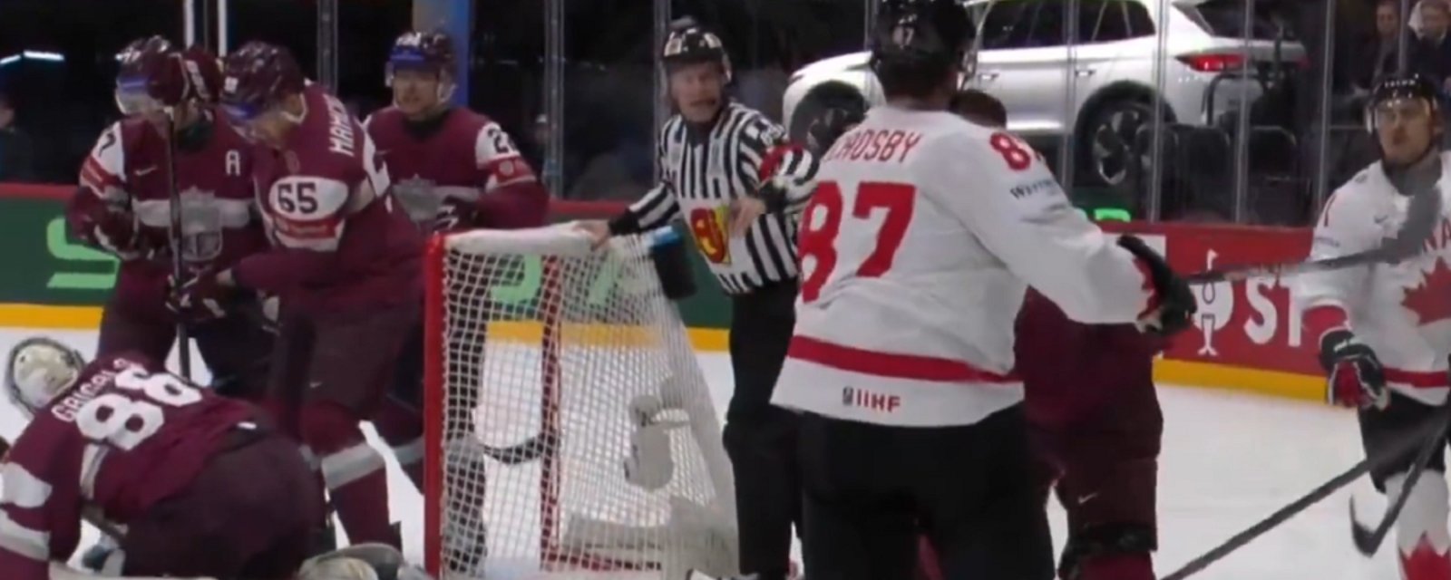 Sidney Crosby punches a players helmet off at World Championship.