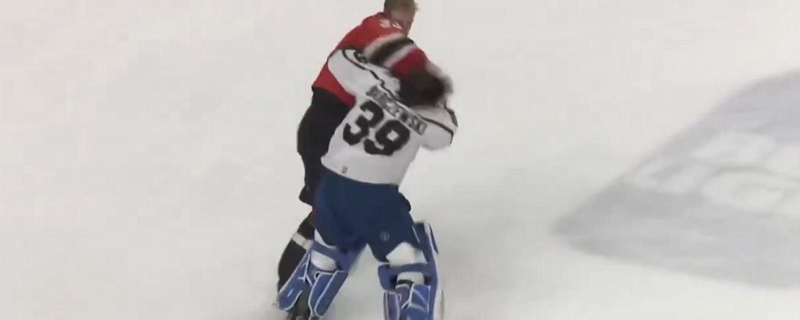 Goalie helped off the ice after challenging the wrong man to a fight.