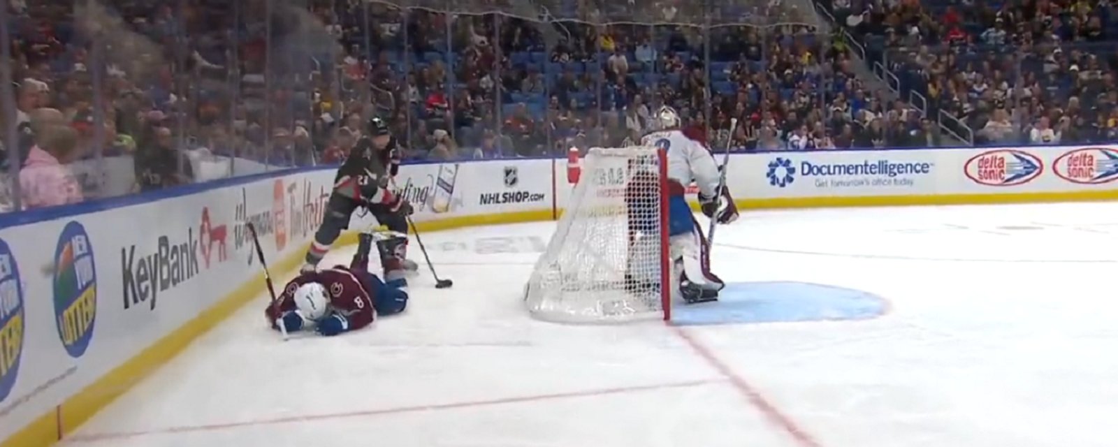 Kyle Okposo sends Cale Makar face first into the boards.