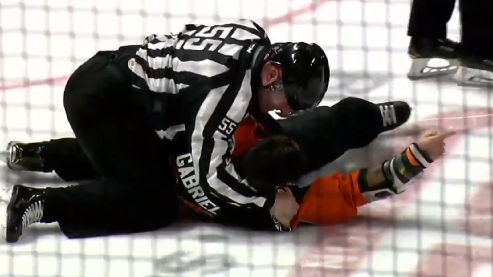 Linesman Richard Jondo slams Kurtis Gabriel to the ice after he refuses to stop fighting.
