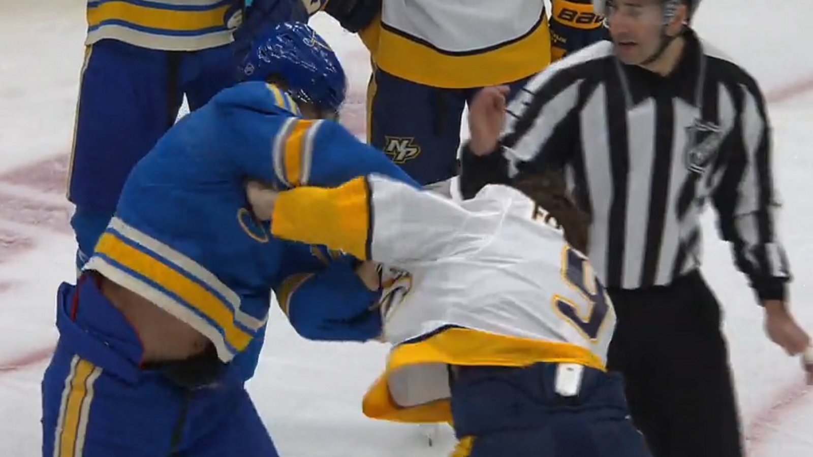 Filip Forsberg and Brayden Schenn drop the gloves in front of the Blues net. 