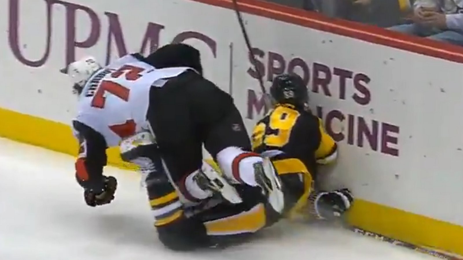 Jake Guentzel goes head first into the boards after scoring a goal.
