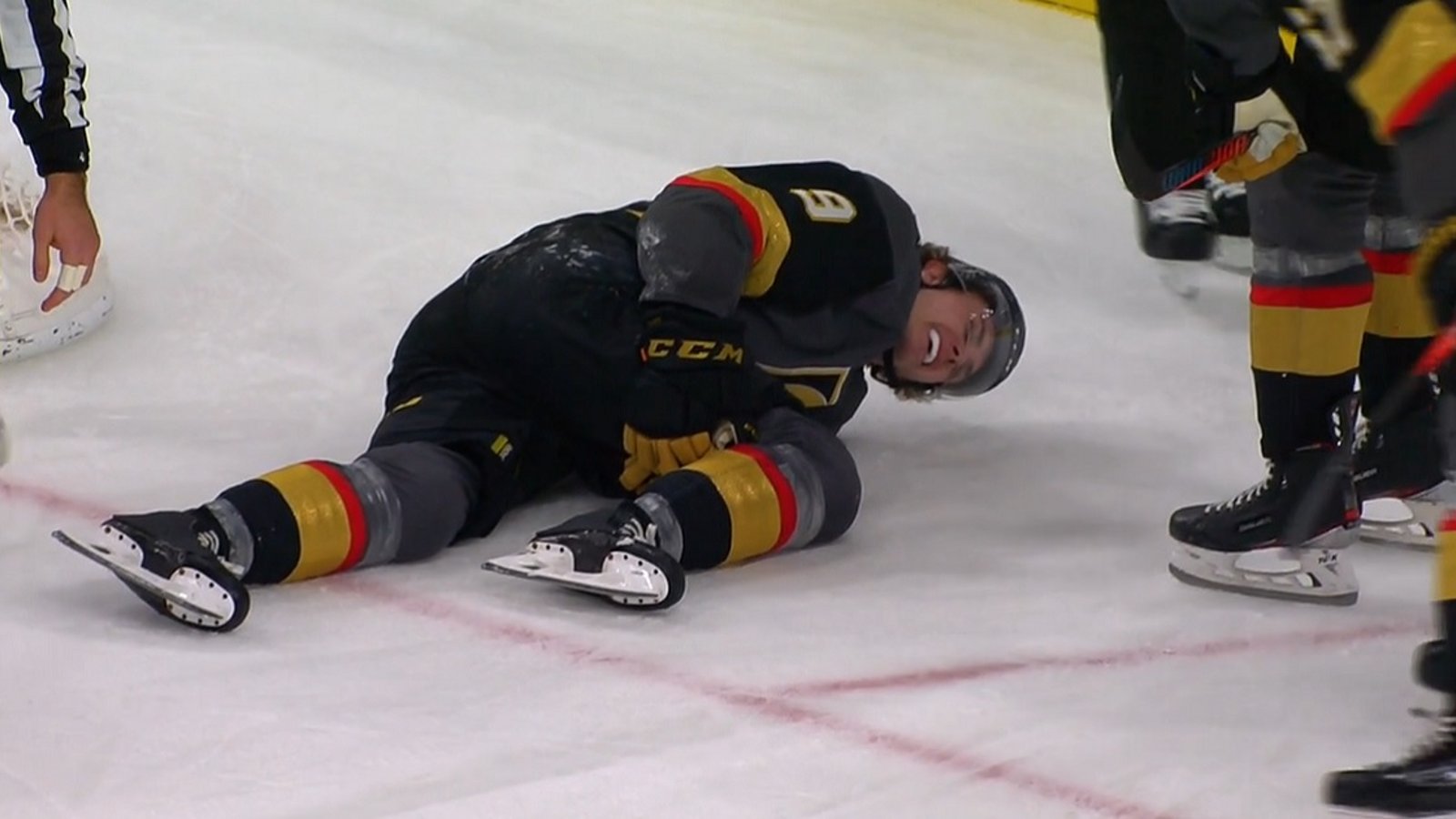 Cody Glass carried off the ice after falling awkwardly into the net.