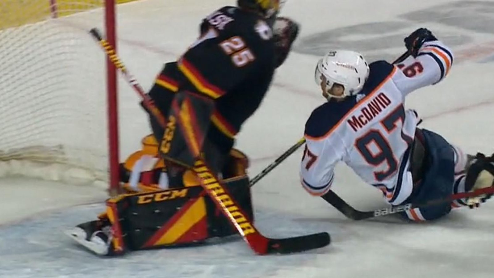Connor McDavid slams into Jacob Markstrom.