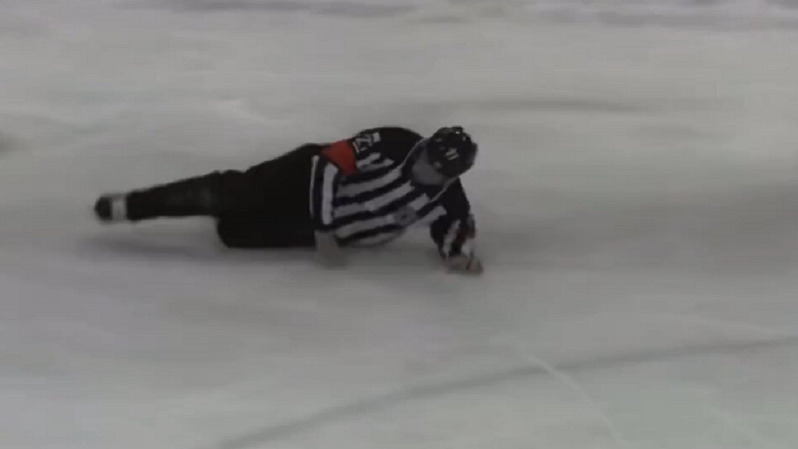 Enraged player attacks linesman while being escorted off the ice.