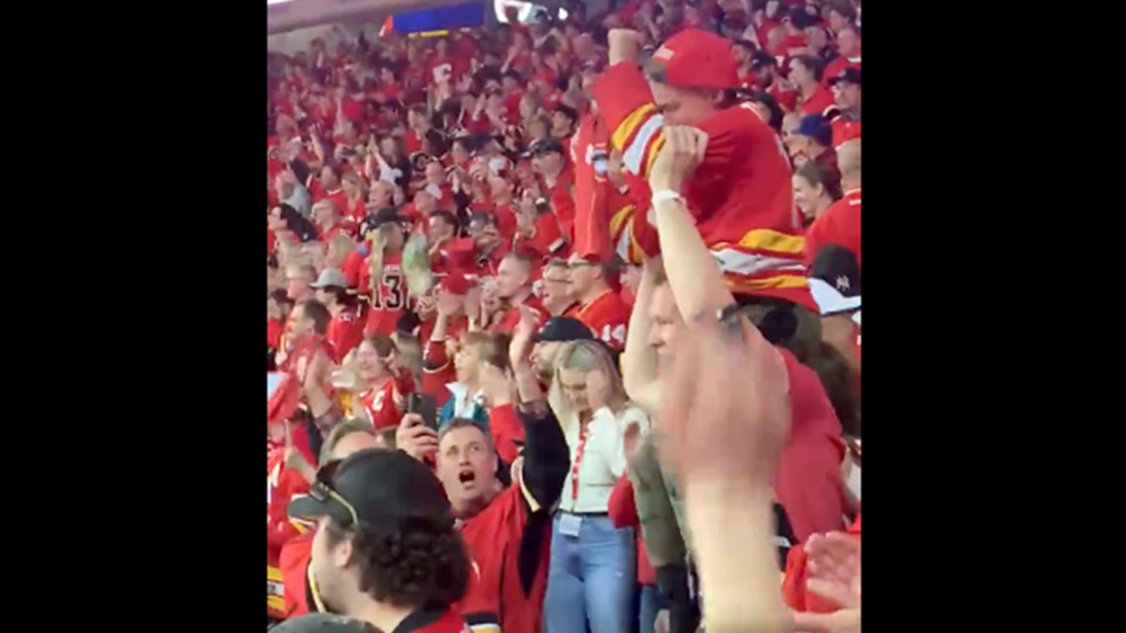 Brady Tkachuk celebrates Flames OT win by hoisting a Matthew Tkachuk fan on his shoulders and running up and down the arena stairs
