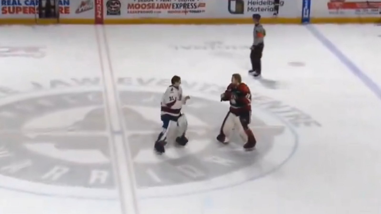 Goalie fight at center ice after all hell breaks loose.