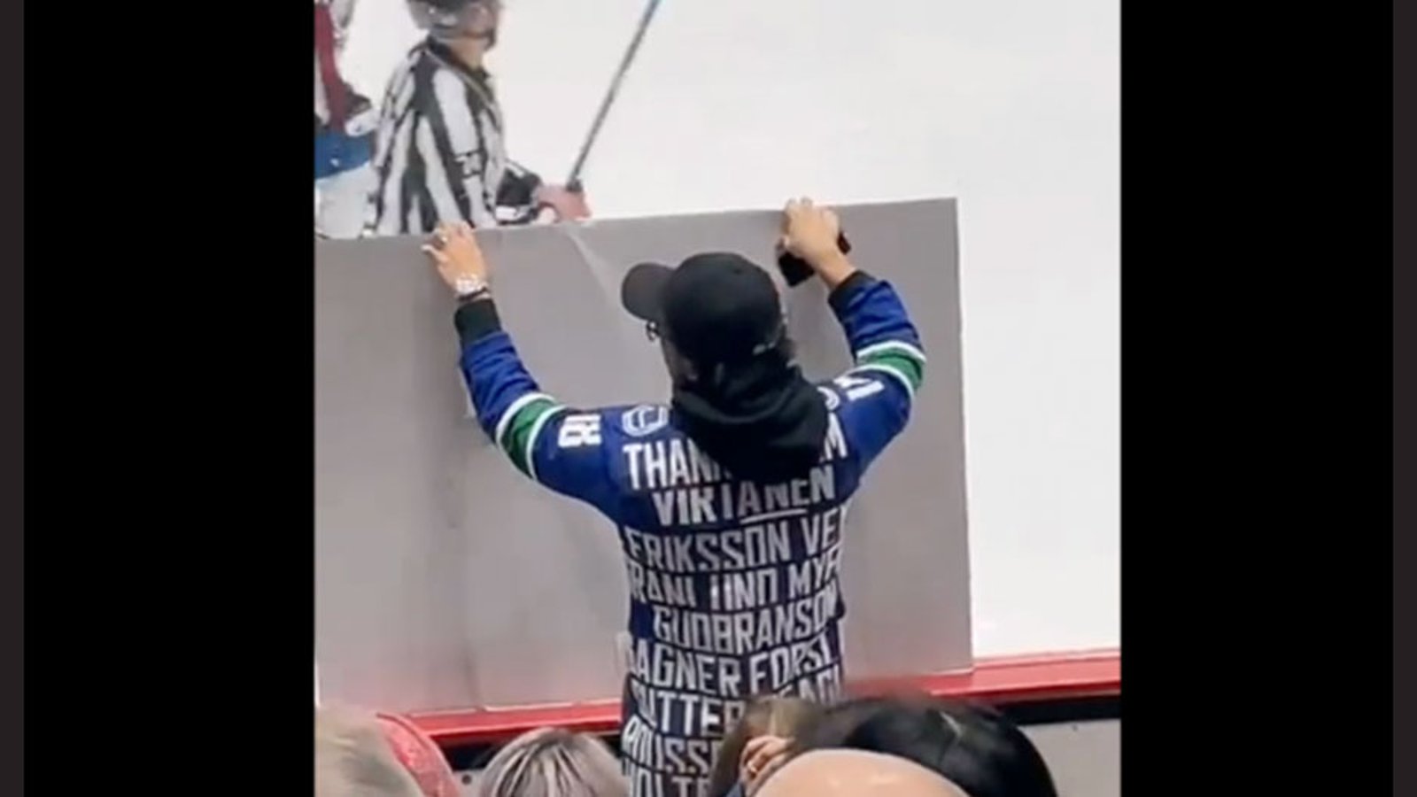 Canucks fan manages to sneak in a hilarious sign, displays it right on the glass