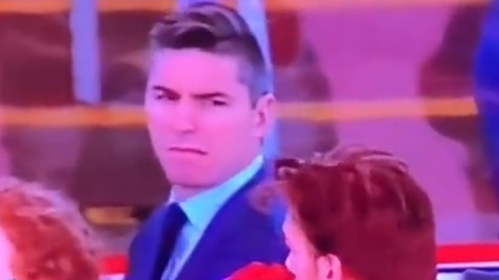 Alex Burrows looks on in disgust as singer butchers Canadian national anthem.