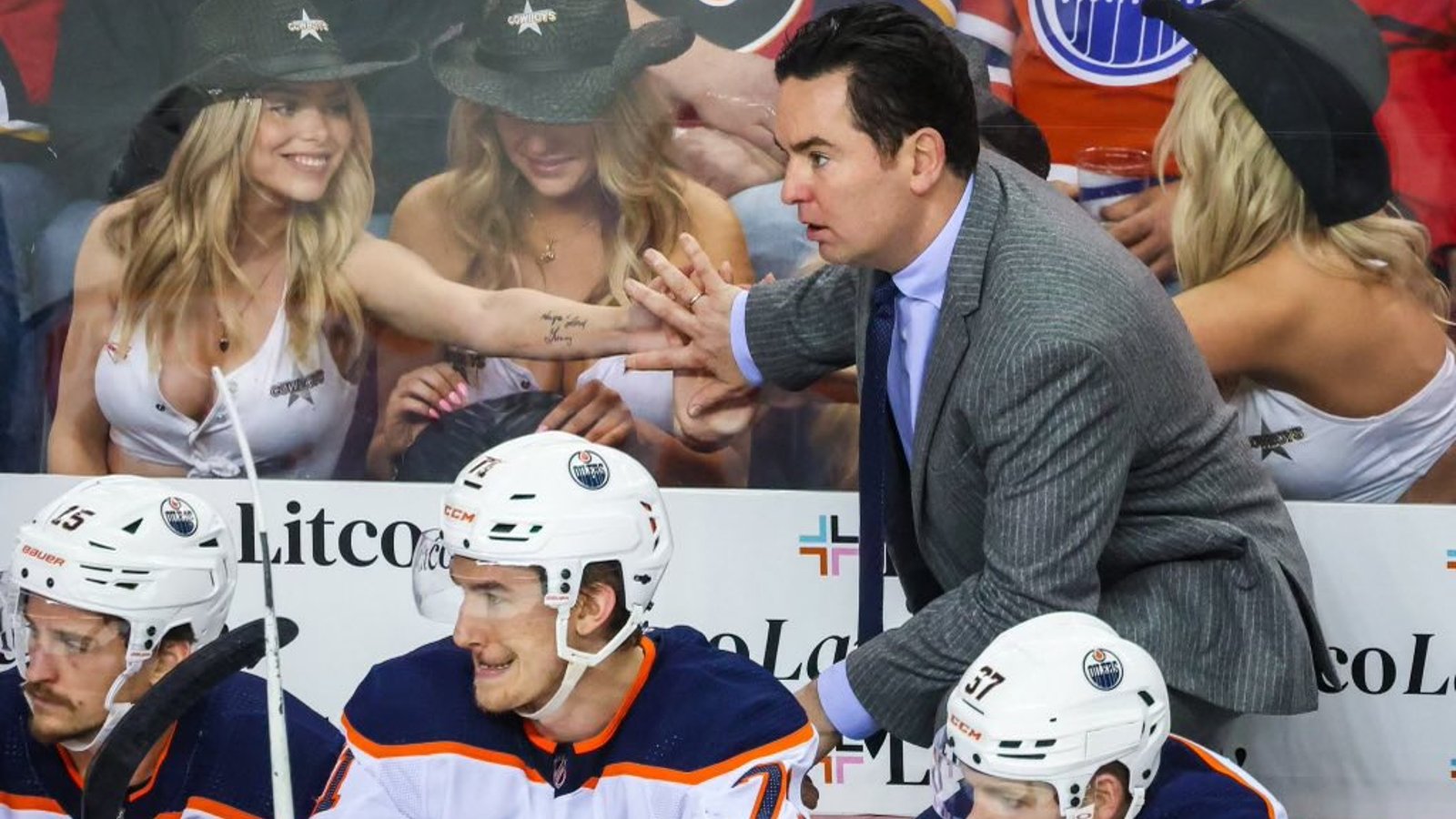The Battle of Alberta got their own beautiful cleavages behind the bench