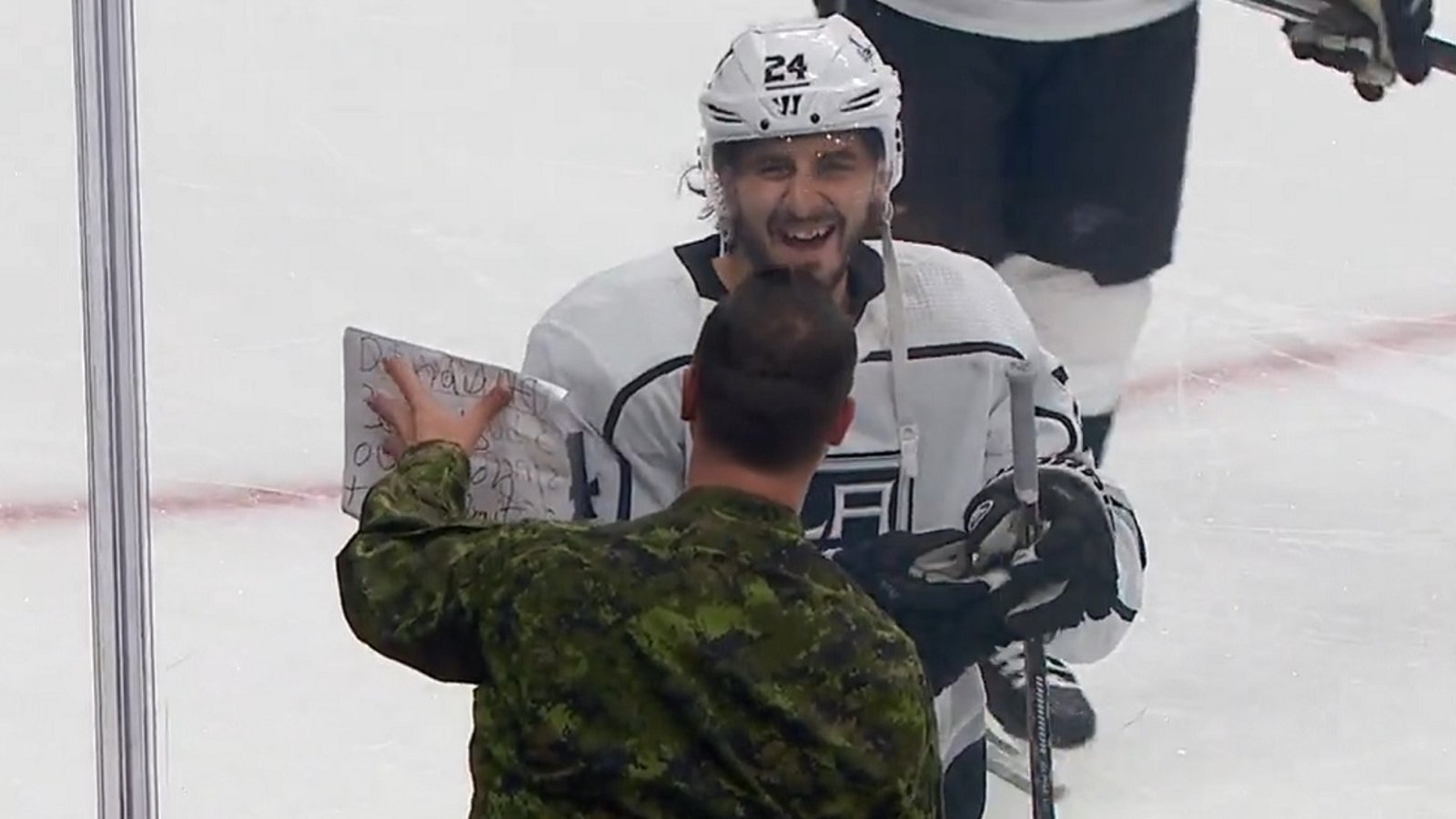Phillip Danault works out a trade with Canadian Armed Forces member during warmups.
