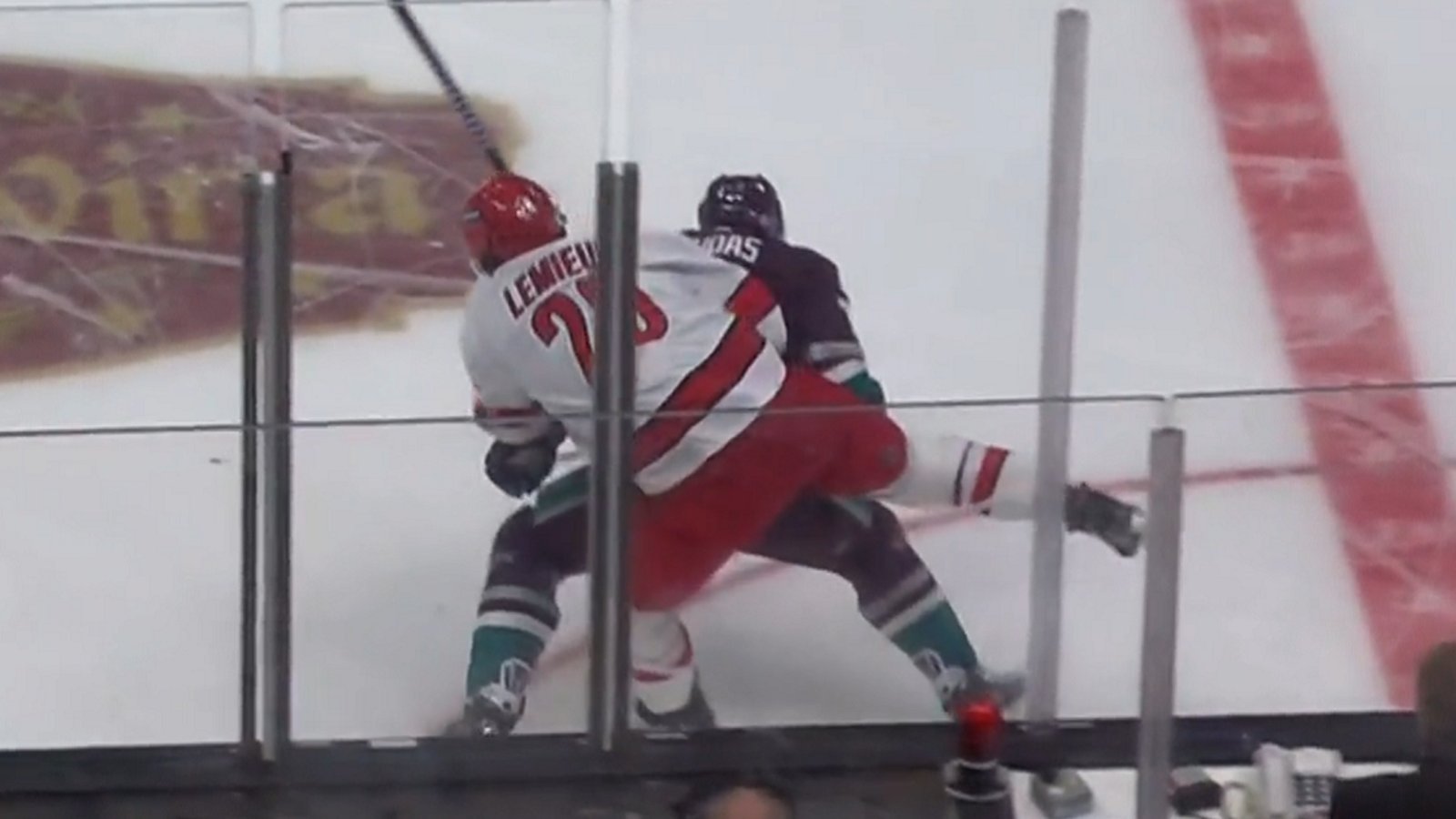 Radko Gudas levels Brendan Lemieux with a hip check.
