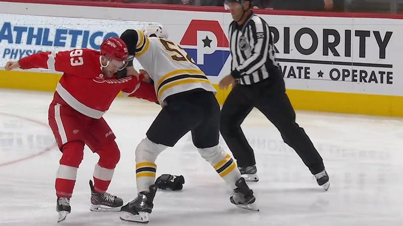 Alex DeBrincat snaps and drops the gloves with Andrew Peeke.