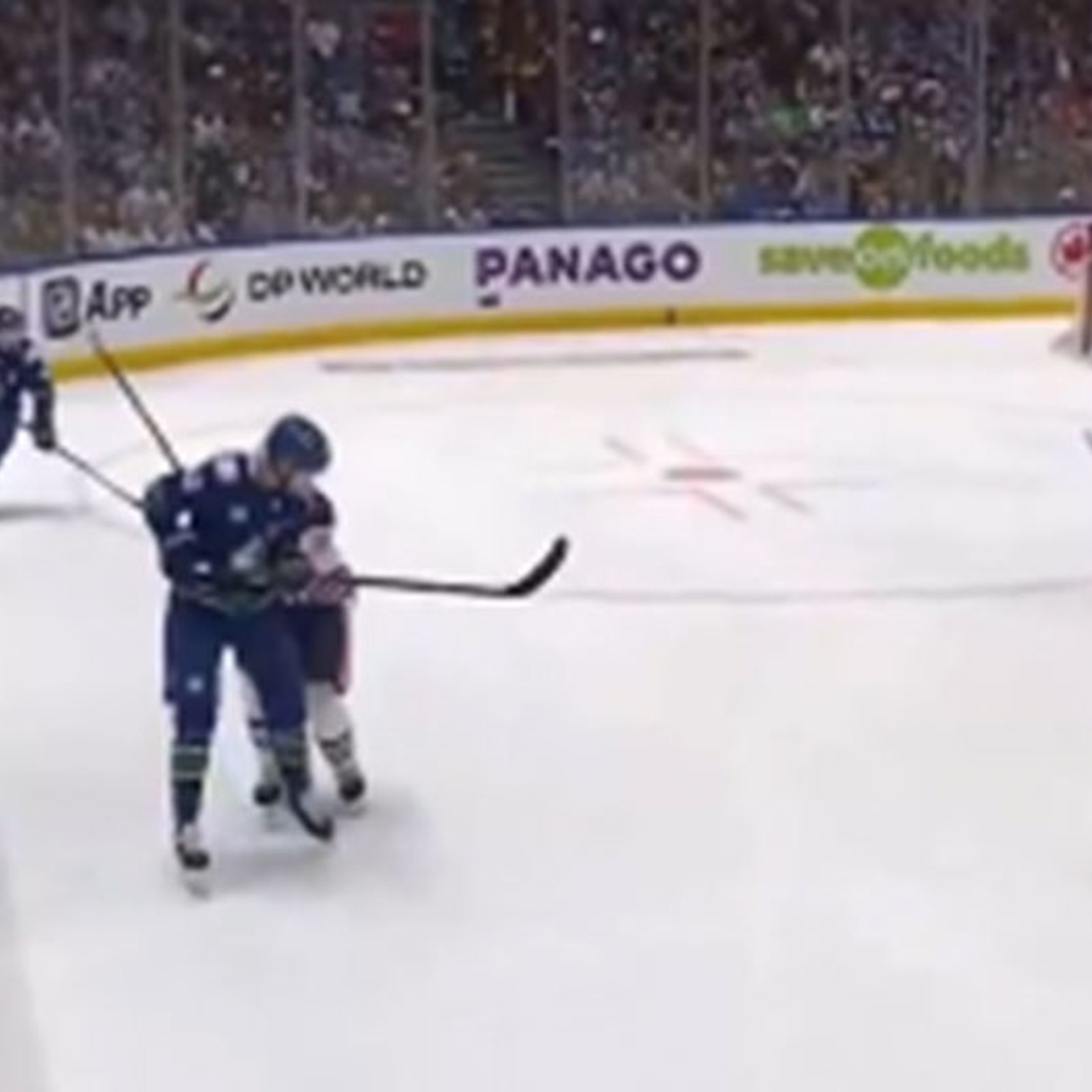 Canucks fans litter the ice with garbage after an absolutely brutal call from the refs