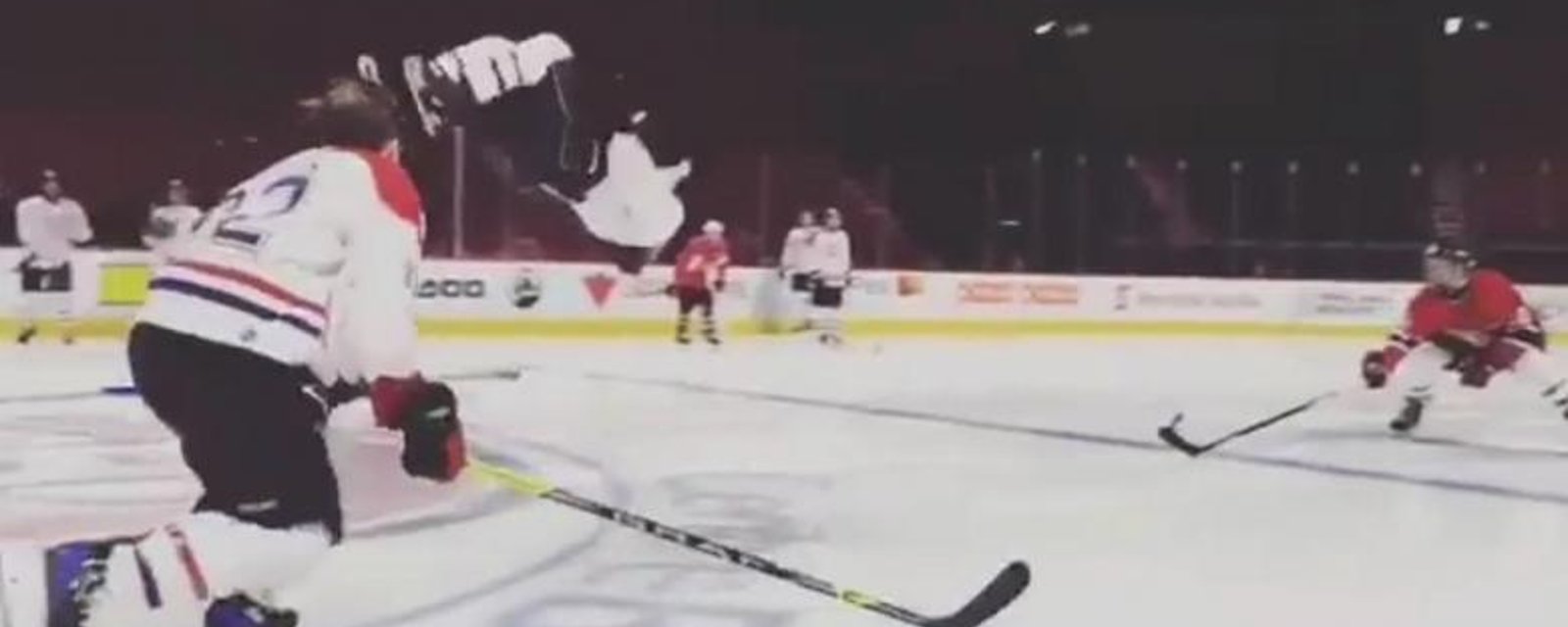 Watch: Unknown player does a back flip on the ice while skating backwards and scores.