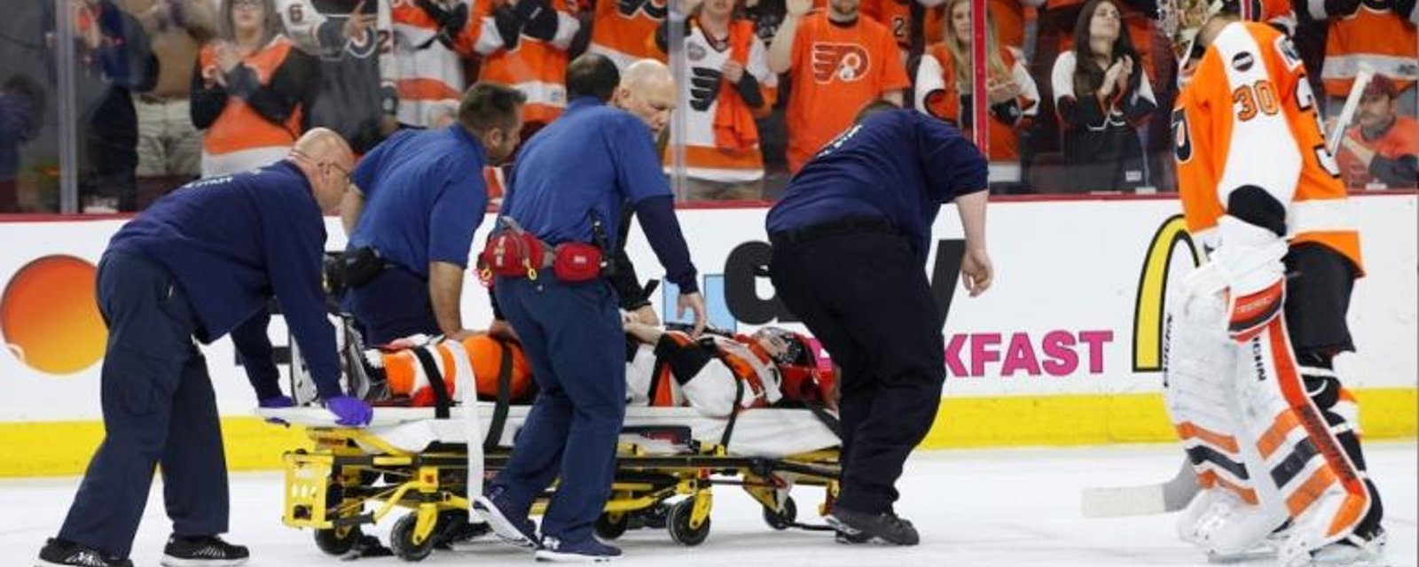 Player stretchered off the ice and sent to hospital after violent hit.