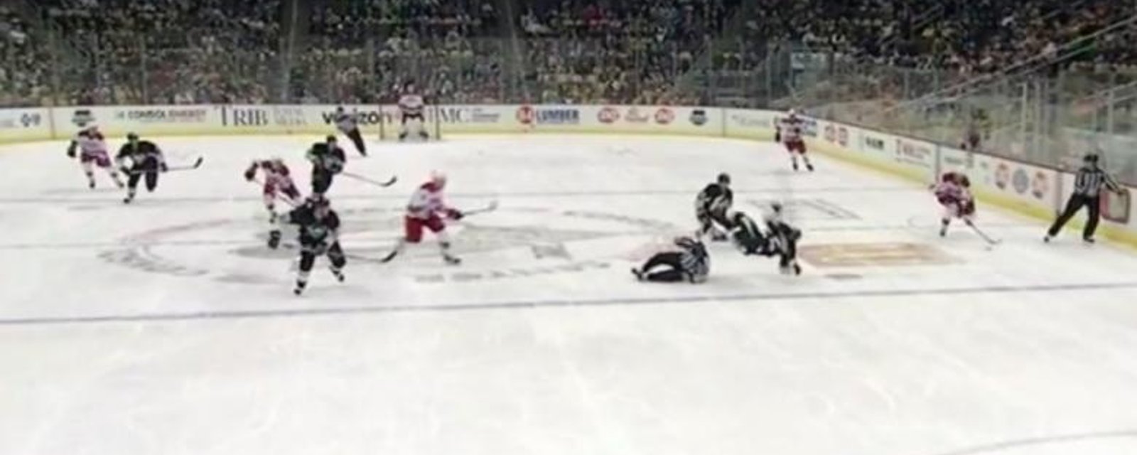 Referee injures defenseman with a brutal hit.