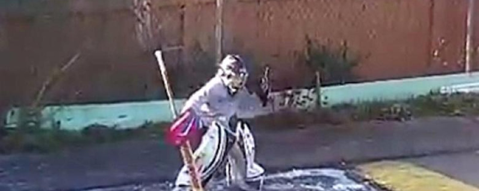 Must See: Young goaltender practices on frozen puddle.