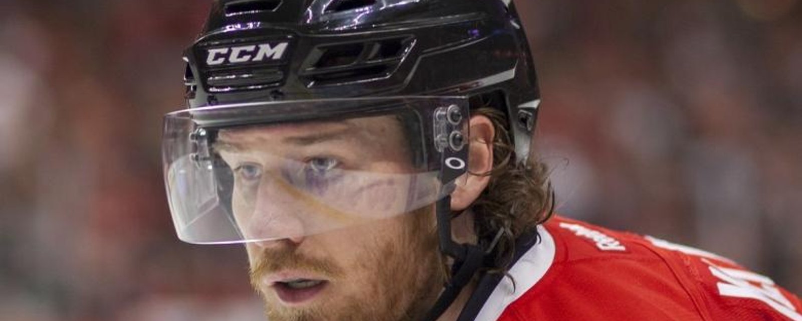 Blackhawks star Duncan Keith swings his stick at another player's face.