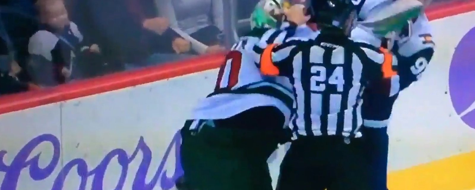 Goalie and player throw punches after clash in the crease.