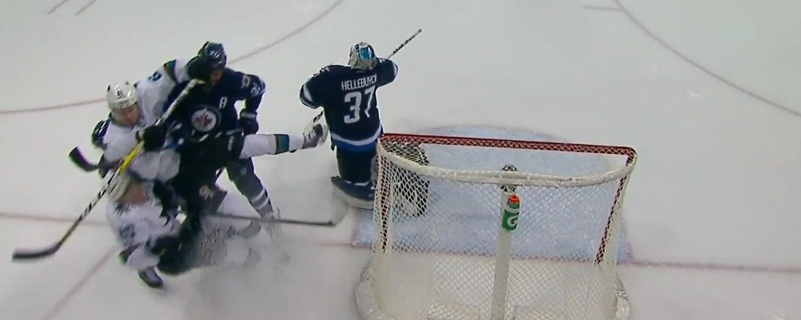 Dustin Byfuglien sends three players crashing into the boards with a single hit.