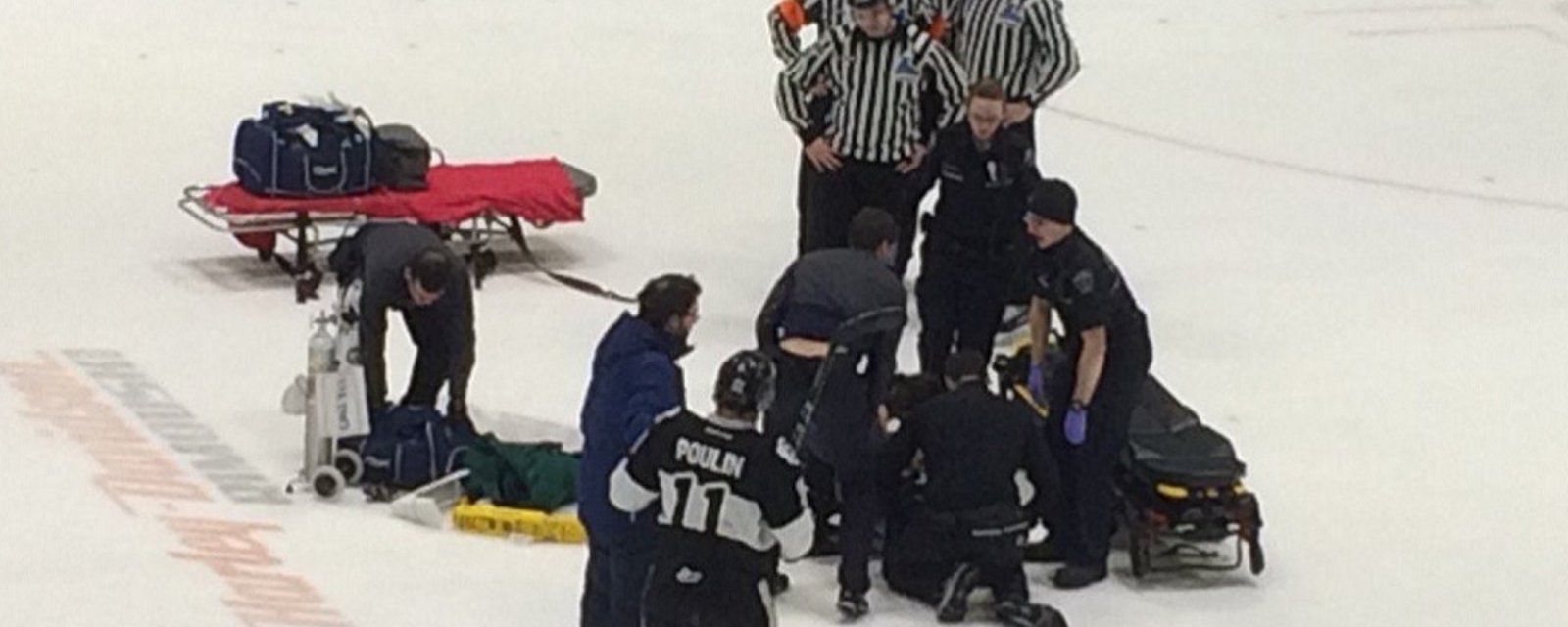 Stretcher brought out and teams sent to the back after player is knocked out cold.