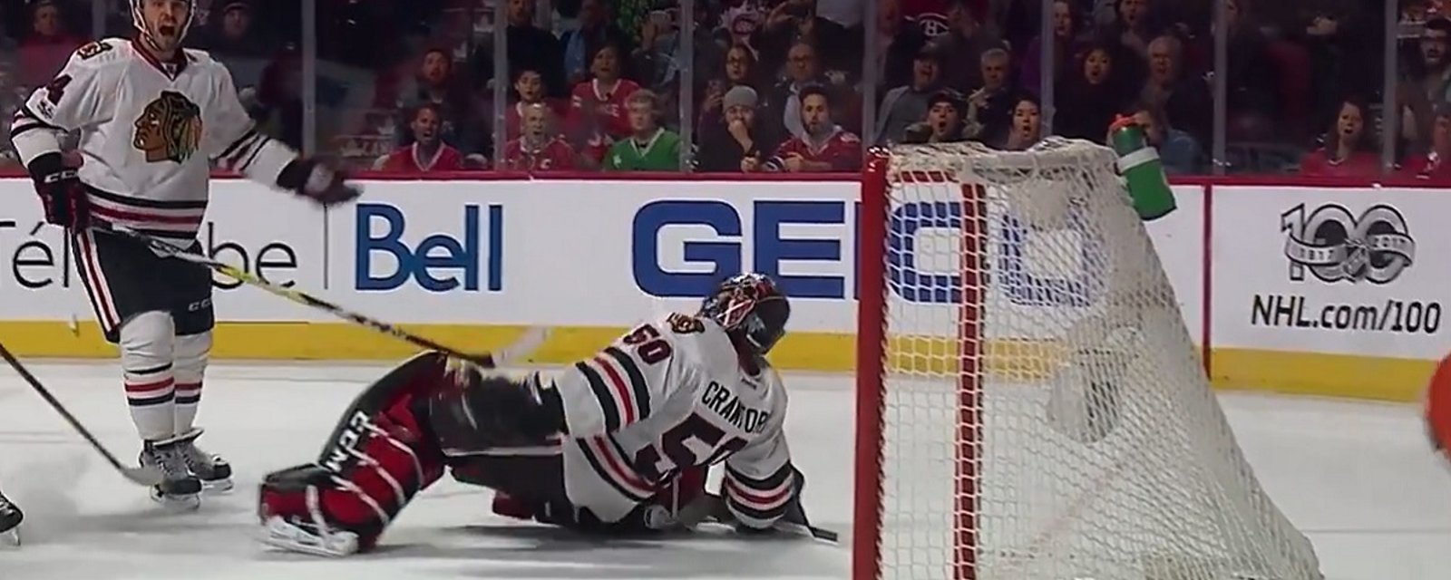 Corey Crawford gets rocked by a headshot from Shea Weber.