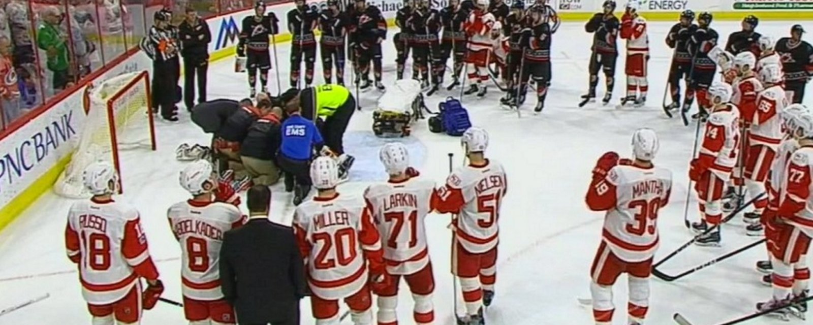 Breaking: Both teams surround the net as stretcher comes out for injured goalie.