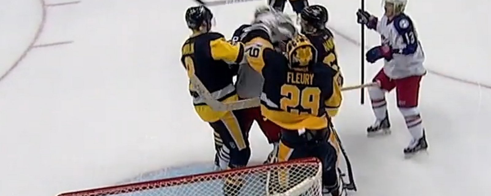 Fleury throws a punch after being slash in front of his net.