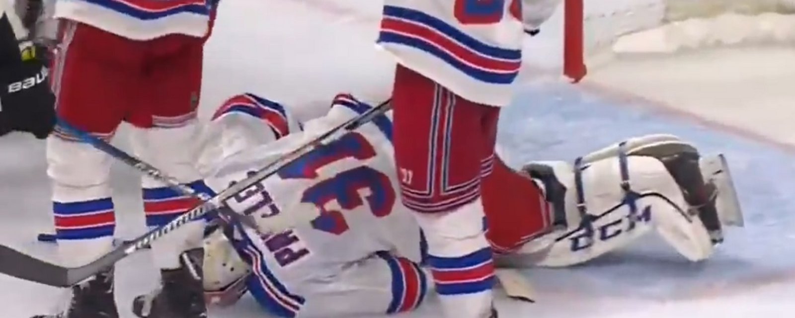 NHL goalie collapses after taking a slap shot to the neck.