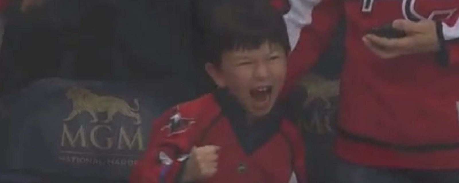 Backstrom gives puck to a young fan, his reaction is unforgettable. 