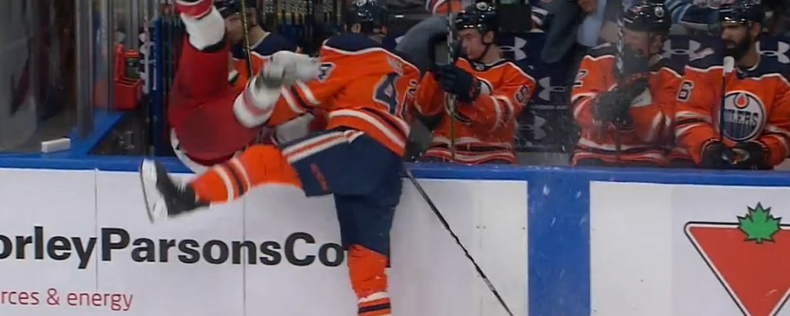 Kassian sends Martinook into the Oilers bench with a big hit!