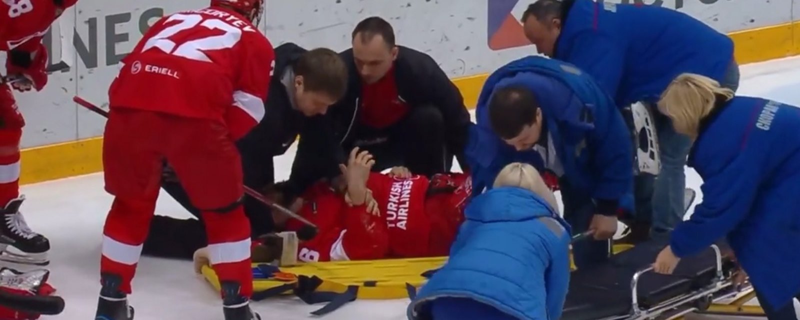 Former NHLer leaves on a stretcher after goalie sends him head first into the boards.