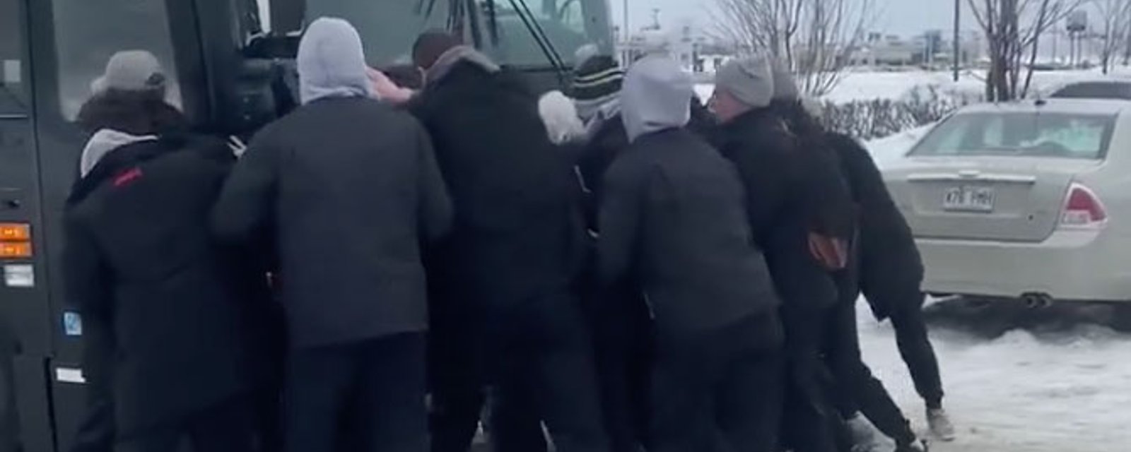 Junior hockey team pushes bus out of snow rut! 