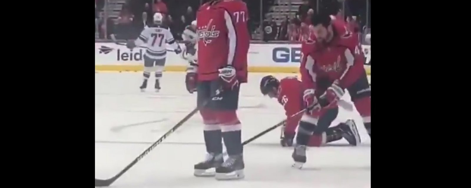 Tom Wilson gives TJ Oshie a low blow before the start of the game.