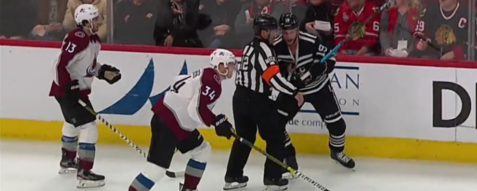 Jonathan Toews nearly slashes referee Justin St. Pierre in frustration.