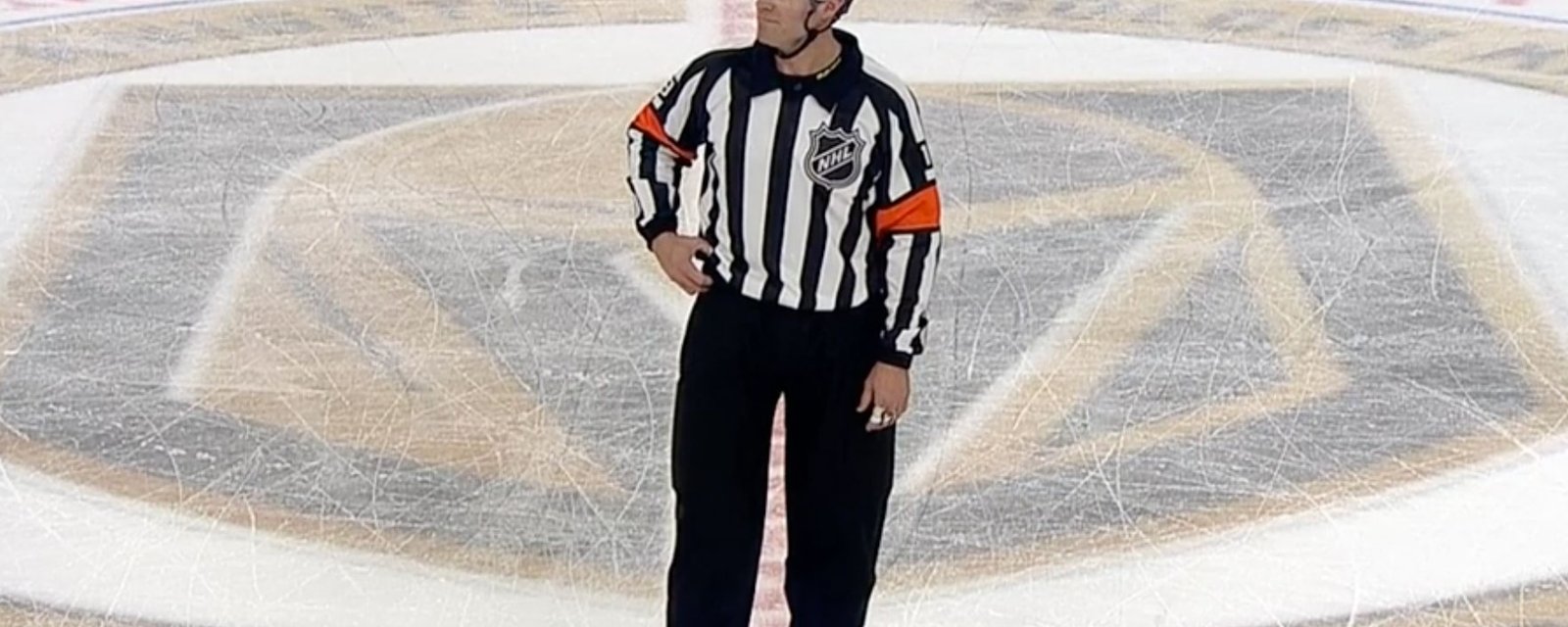 Referee Gord Dwyer is rudely interrupted while making a call during the CHI-VGK game