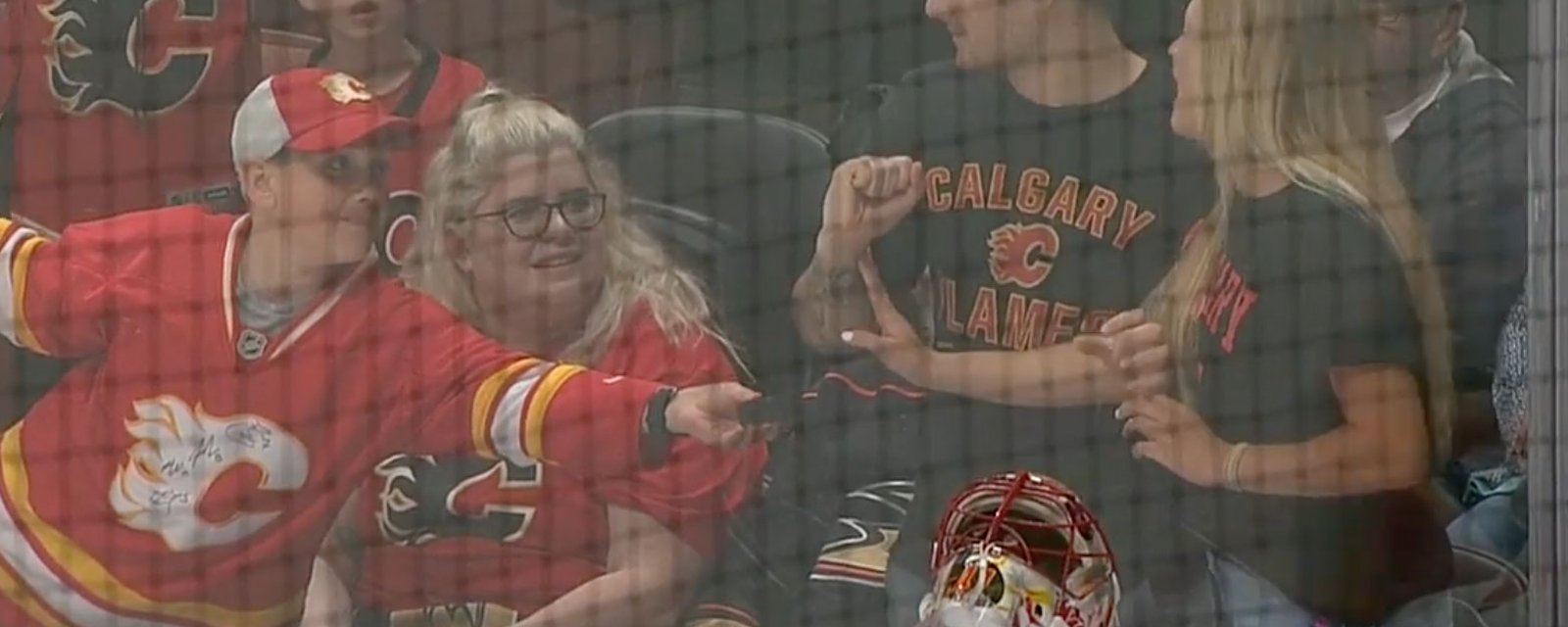 Beautiful woman tears up after young Flames fan gives her his puck! 