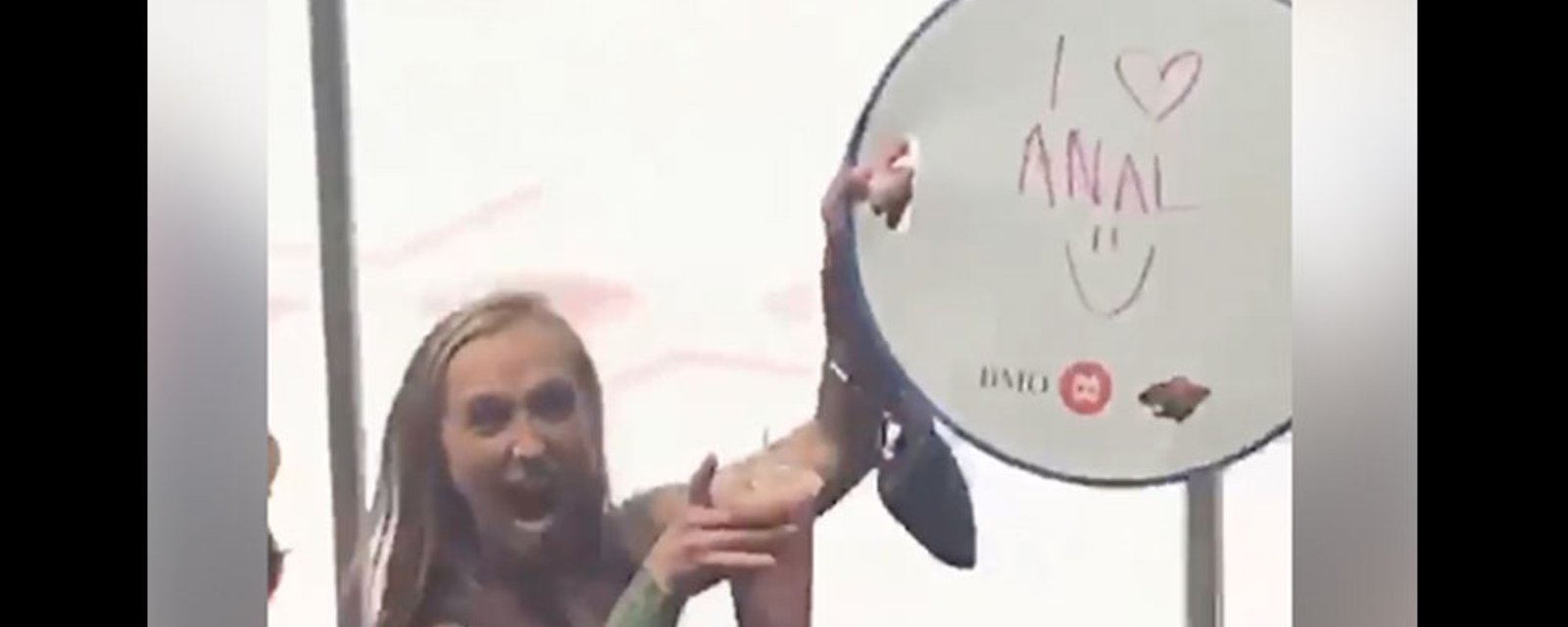 Wild fan dances in the crowd, holds up “I love anal” sign