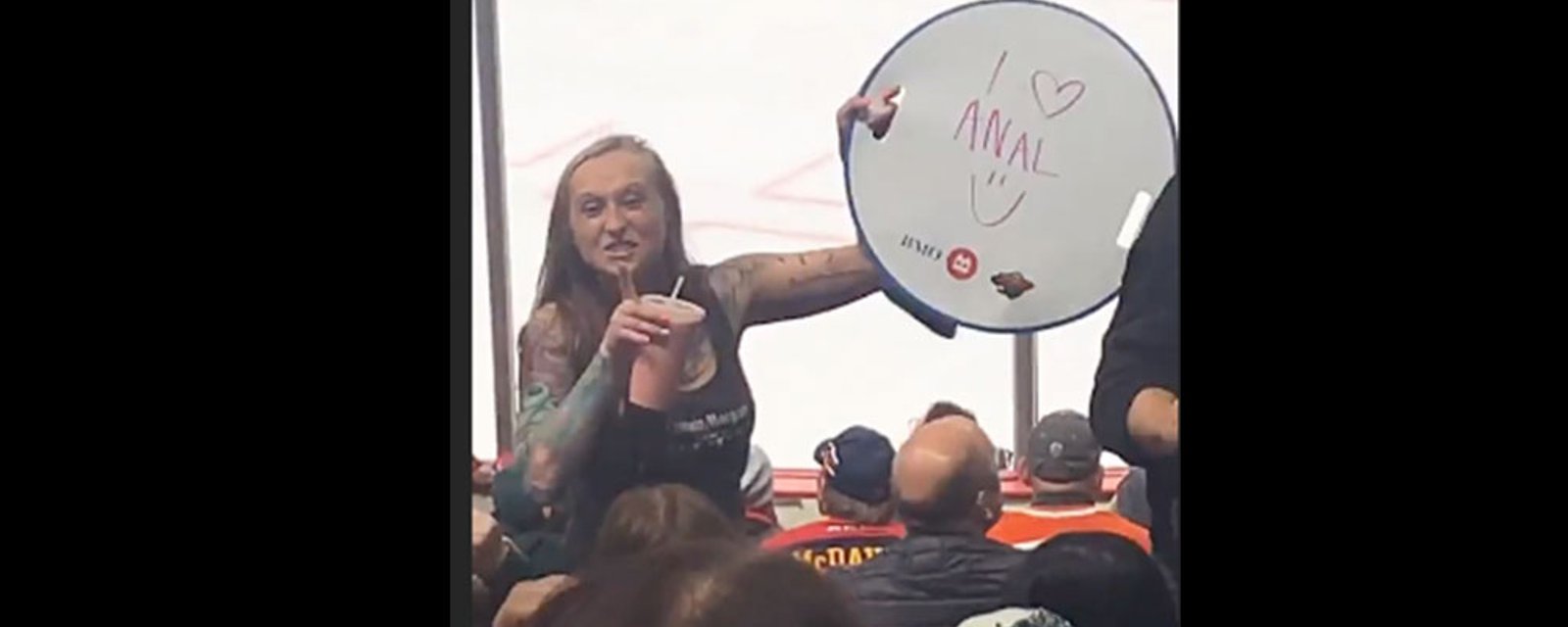 Woman flashes “I Love Anal” sign at NHL game and the crowd goes wild!